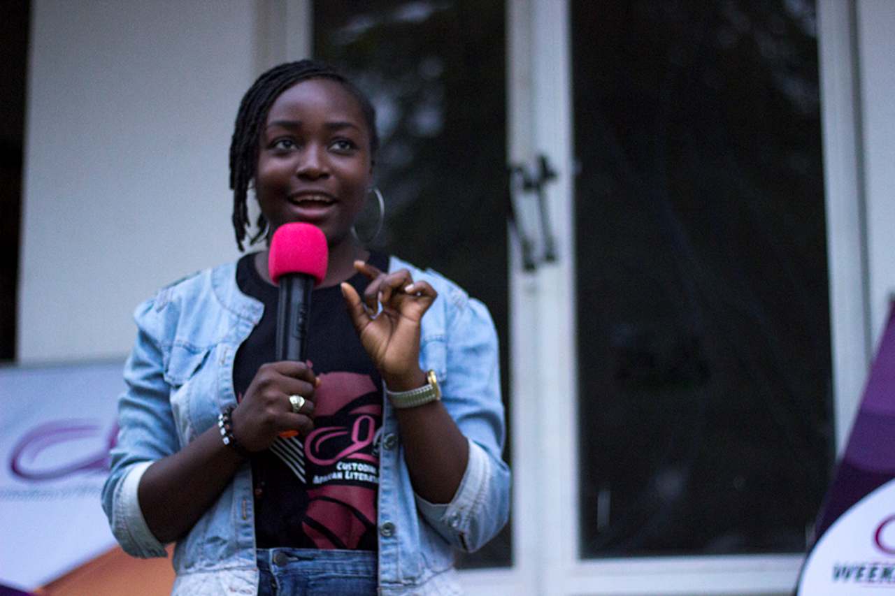 A young woman performing at the microphone